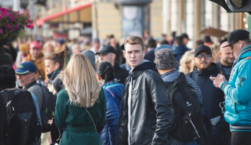 A crowd of people walking down a street.