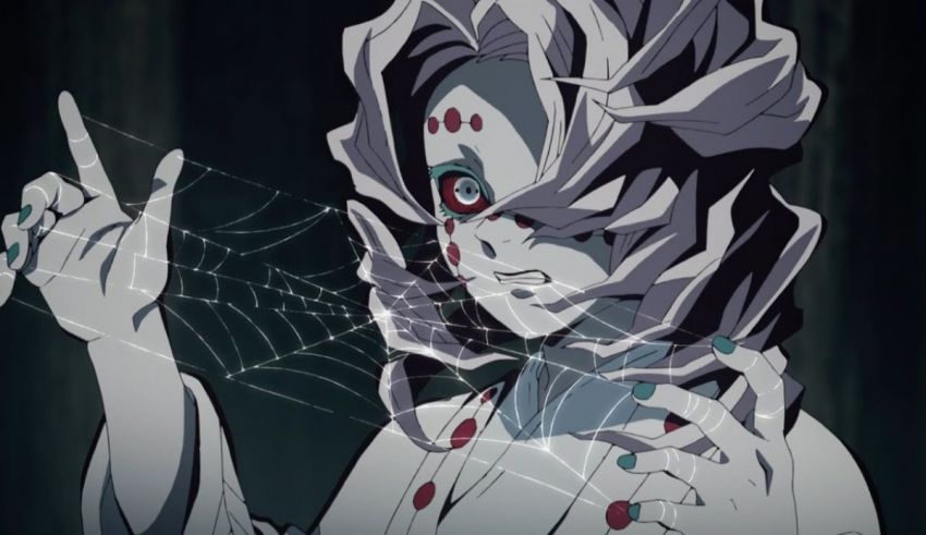 An anime girl holding a spider web in her hands.