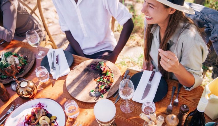 A group of people sitting at a table and eating food.