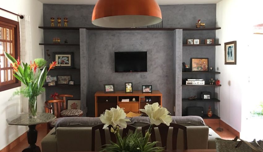 A living room with a tv and bookshelves.