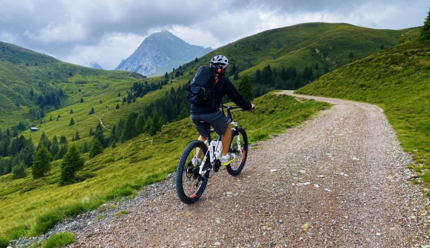 A person riding a mountain bike on a dirt road.