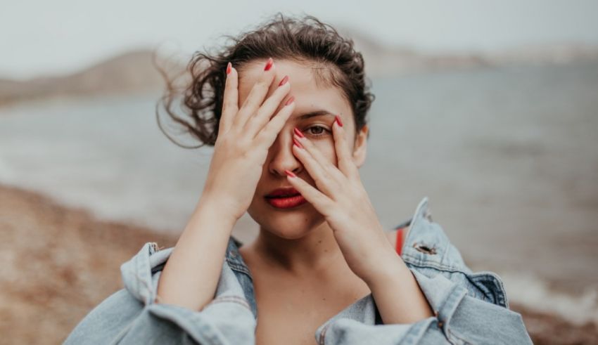 A woman covering her eyes with her hands.