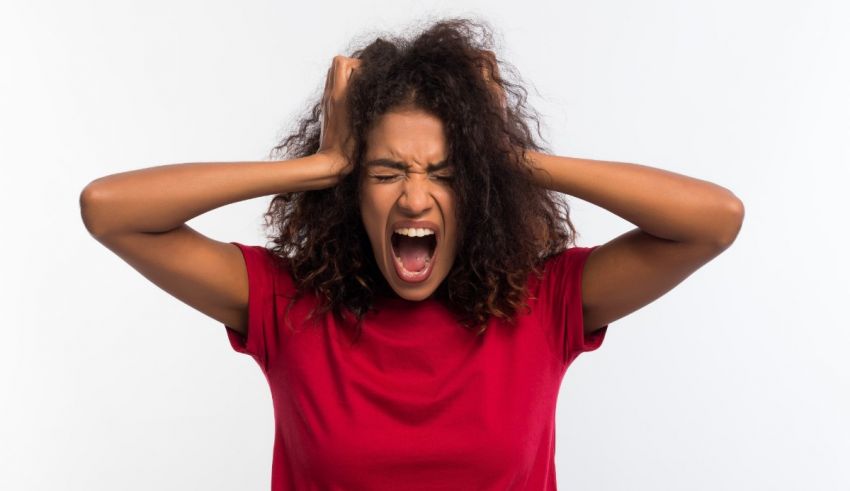 Young african american woman yelling on white background.