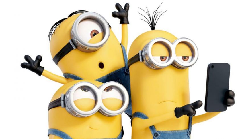 A group of minions holding up a cell phone.