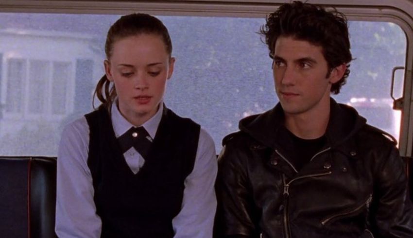 A young man and woman sitting on a bus.