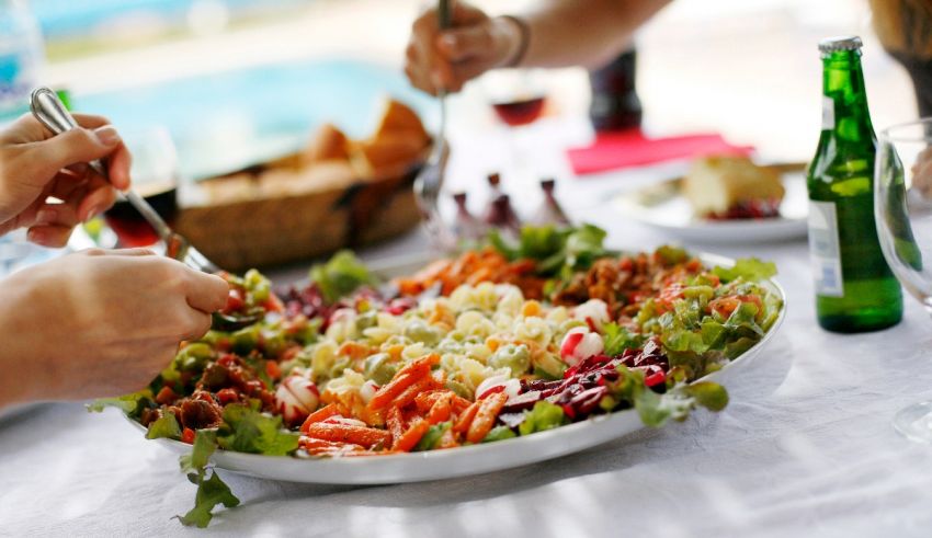 A group of people eating a salad at a party.