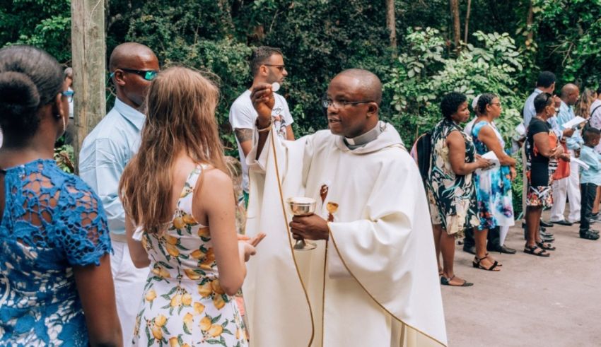 A priest is giving a blessing to a group of people.