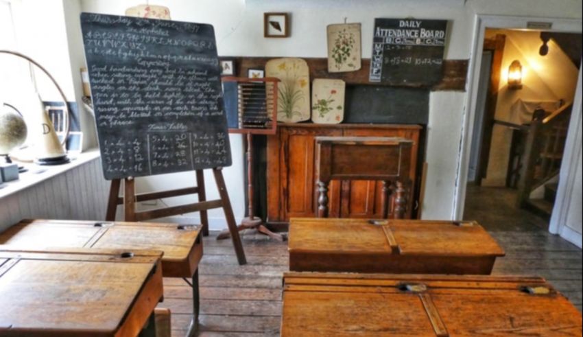 A classroom with a chalkboard and desks.