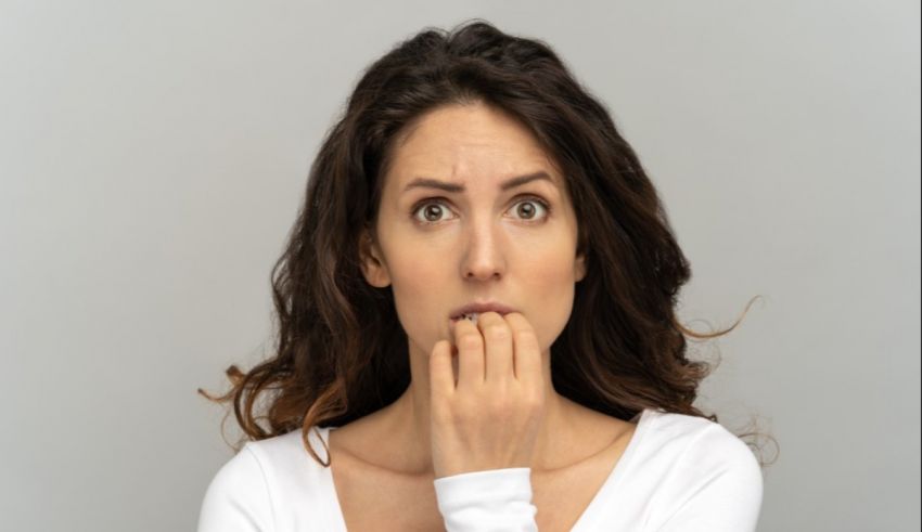 A woman with her hand on her mouth.