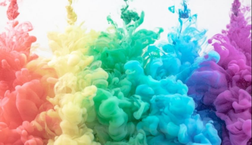 A rainbow of colored ink is floating in the air.