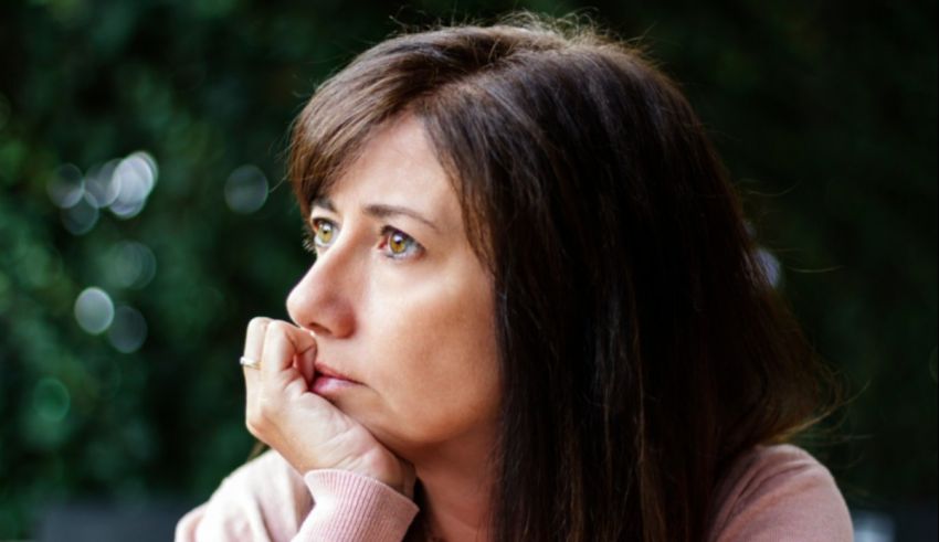 A woman with her hand on her chin.