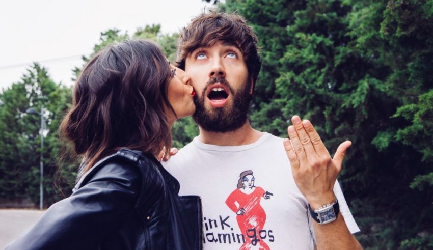A woman kissing a man's cheek.