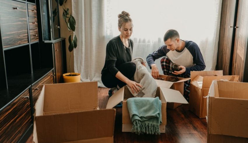 A man and woman unpacking boxes in their new home.