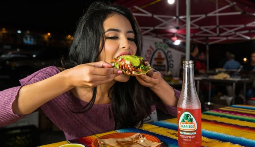 A woman eating a taco at a mexican restaurant.