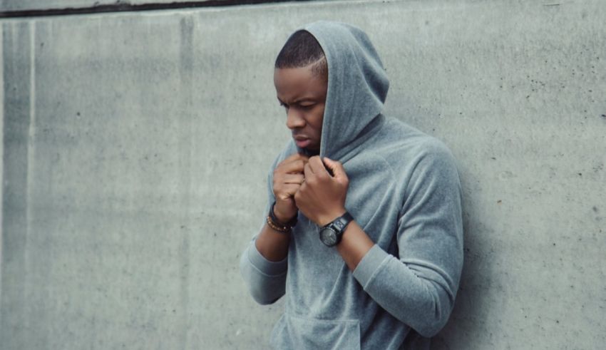 A man in a grey hoodie.