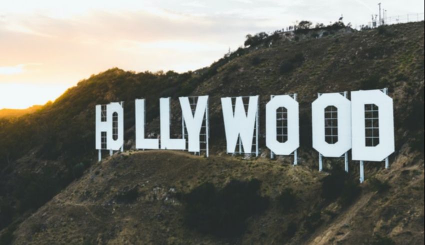 The hollywood sign is on top of a hill.