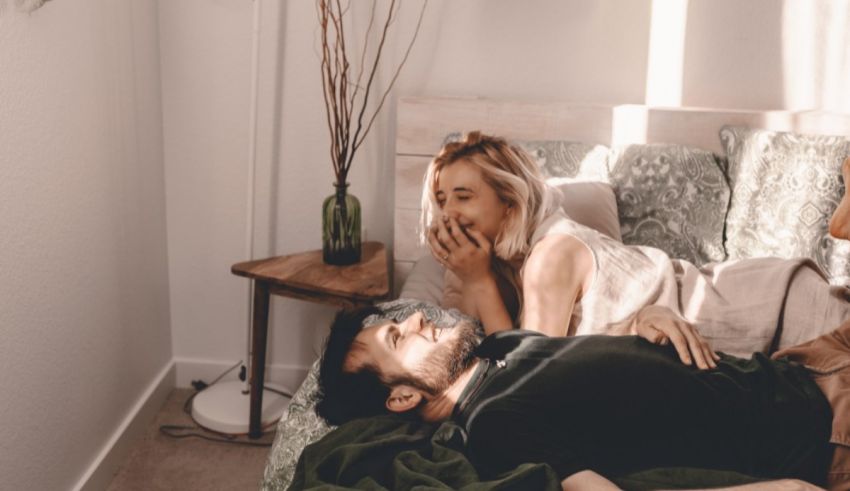A man and woman lying on a bed.