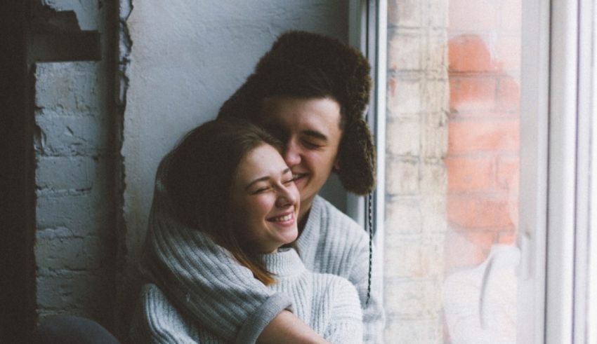 A man and woman hugging each other.