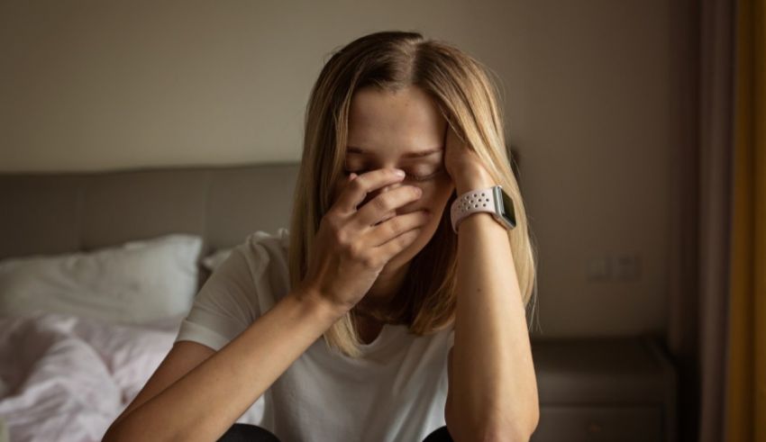 A woman with her hand over her face.
