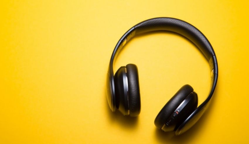 A pair of headphones on a yellow background.