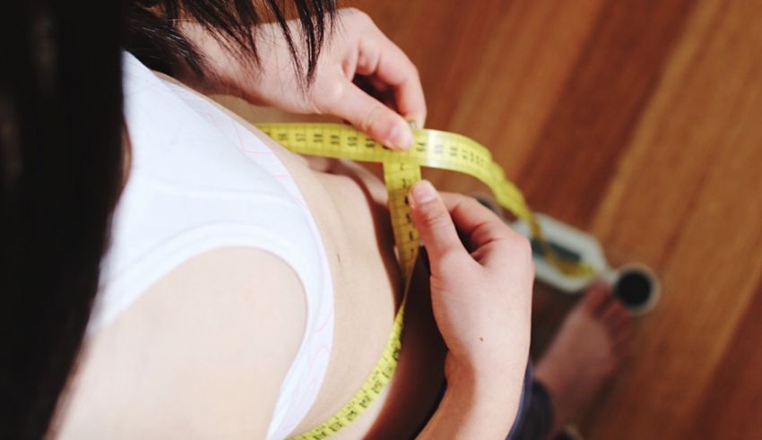A person measuring her waist.