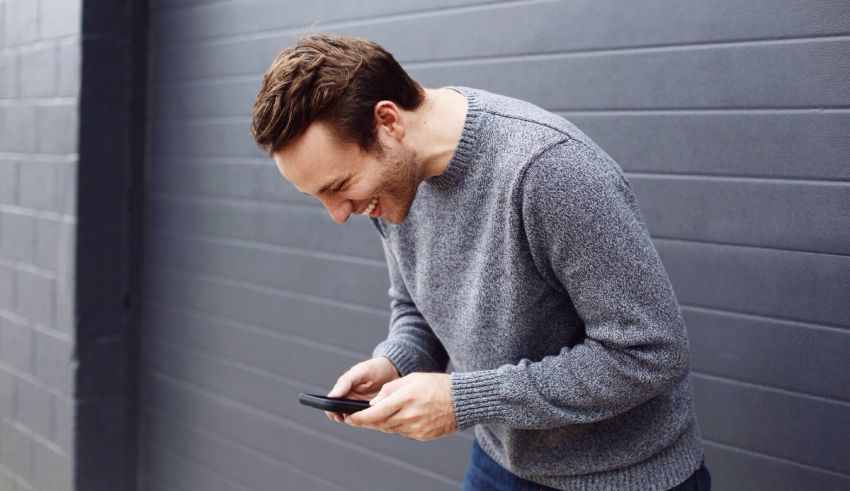 A man is looking at his cell phone.