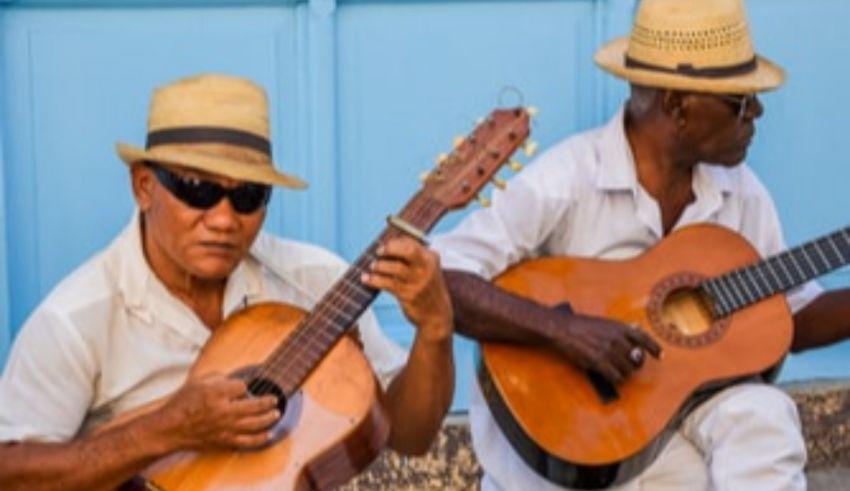 Two men in white hats playing guitars.