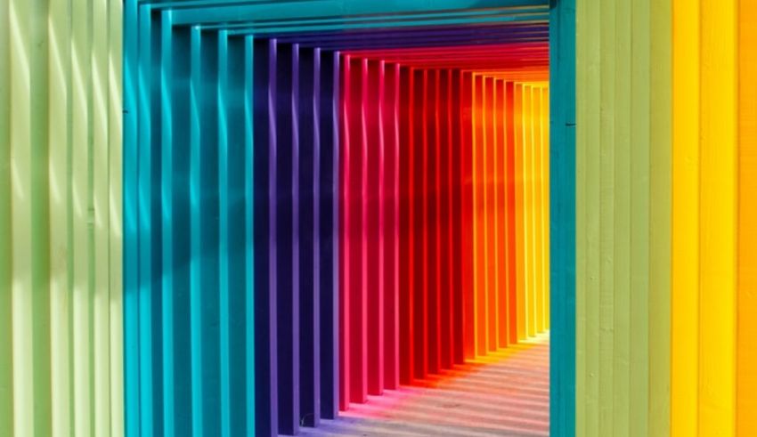 A colorful tunnel with rainbow colored vertical slats.