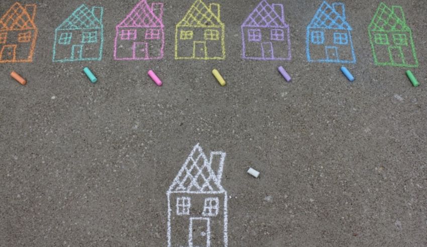 Chalk drawings of houses on the ground.