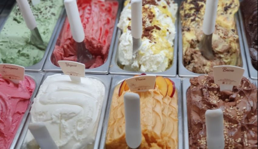 A group of ice cream in containers.