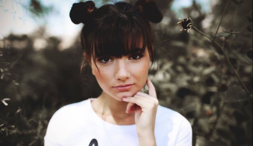 A woman with her hand on her chin.