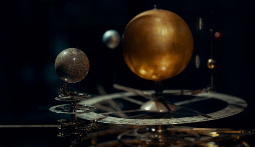 A clock with a golden egg on top of it.