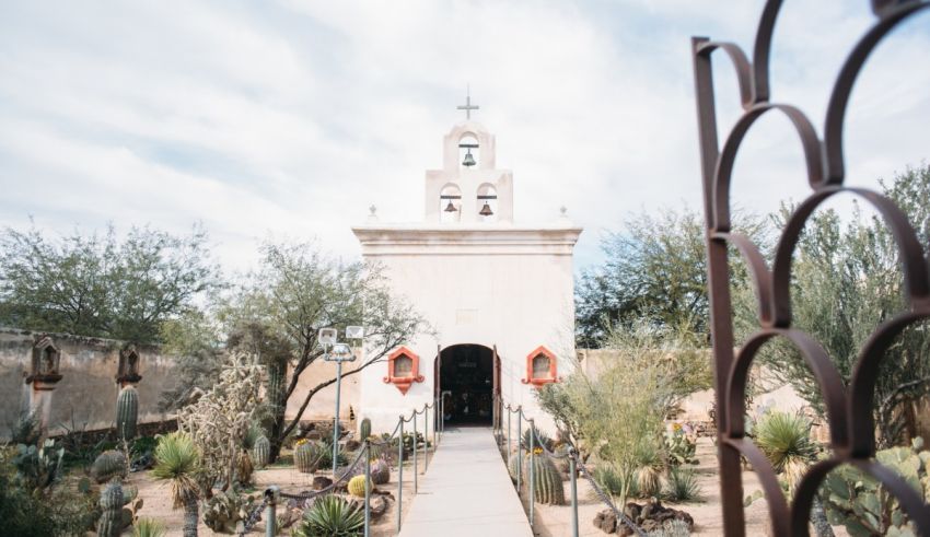 A church with cactus plants in the desert.