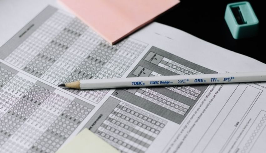 A pencil sits on top of a piece of paper.