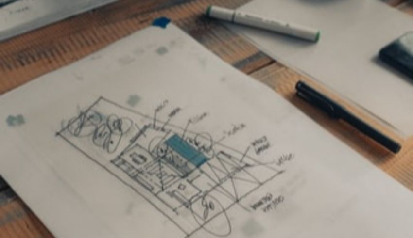 A drawing of a room on a table with pens and pencils.