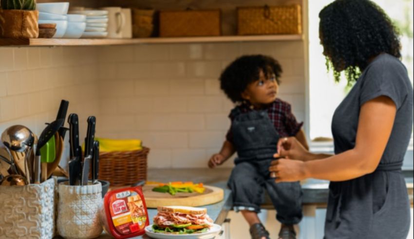 A woman and a child in the kitchen.