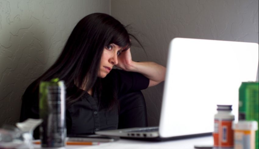 A woman looking at a laptop.