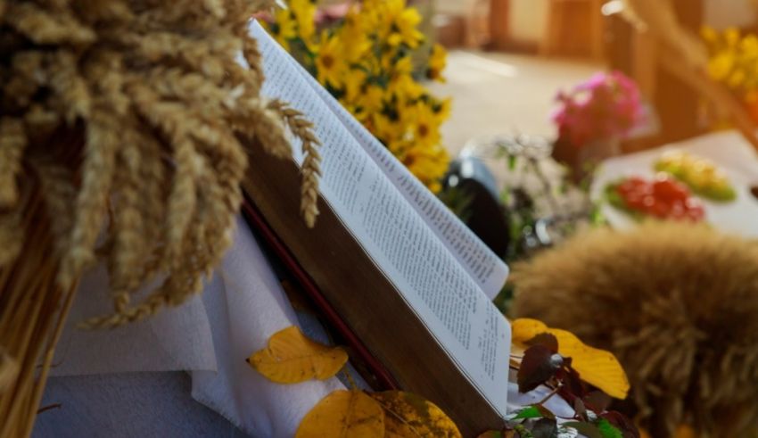 A book on a table with yellow flowers.