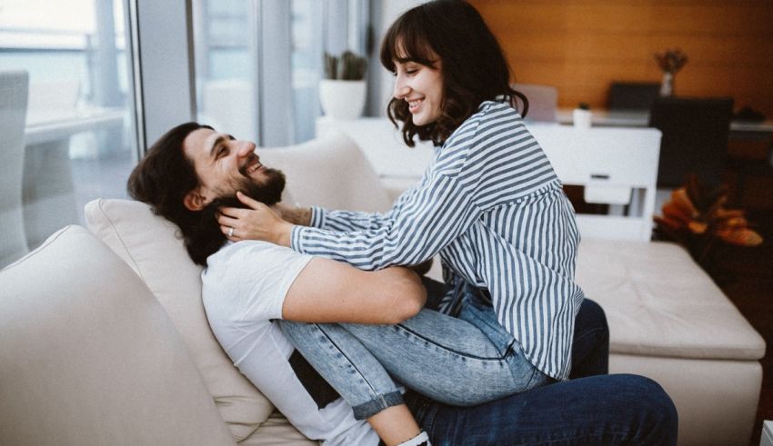 A man and woman sitting on a couch together.