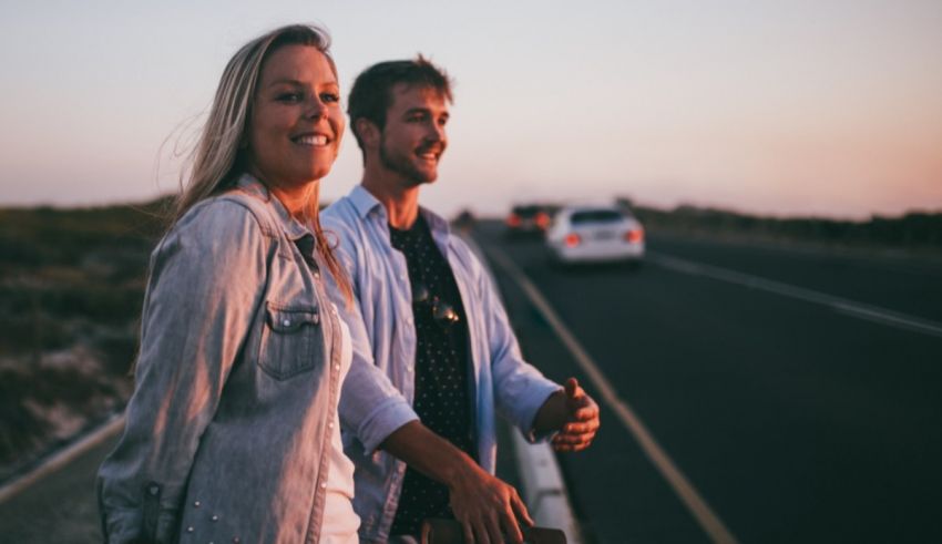 A man and woman standing on a road.