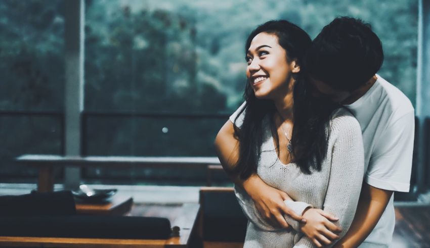 A man hugging a woman.