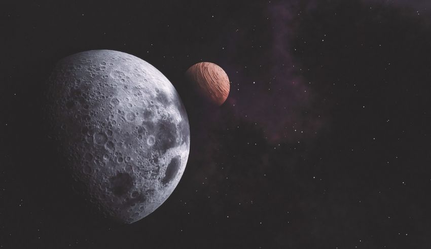 A moon and a planet in the night sky.