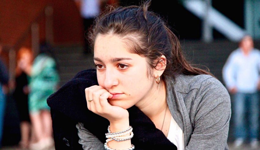 A girl sitting on a bench.