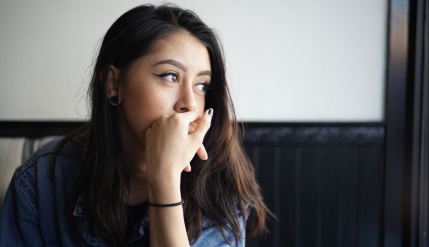 A woman with her hand on her mouth.