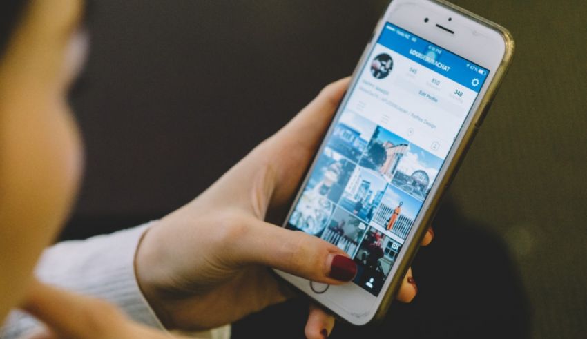 A woman holding a cell phone with pictures on it.