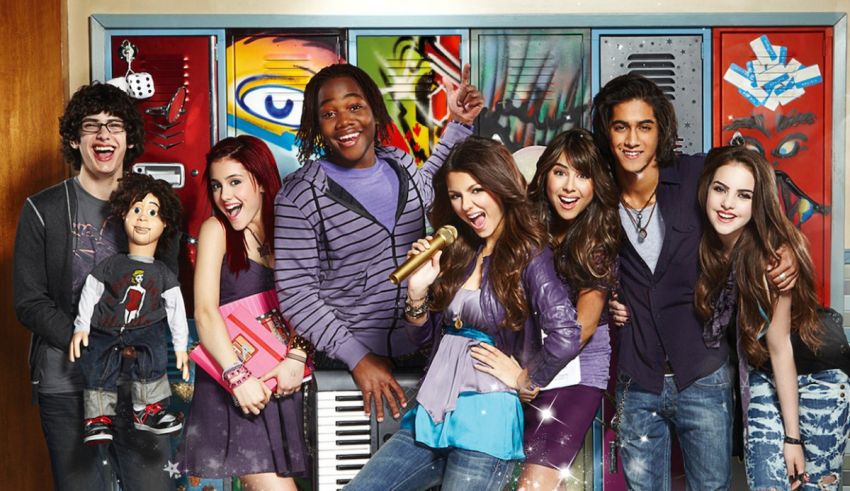 A group of people posing in front of a wall of lockers.