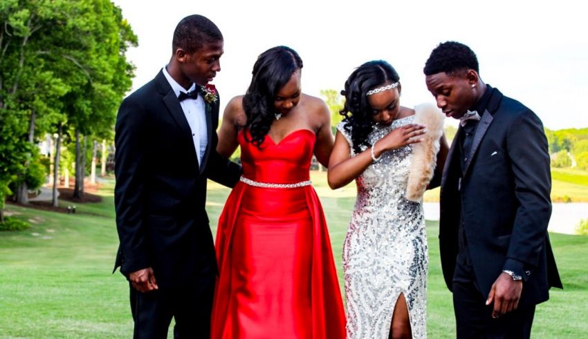 A group of people in formal attire posing for a photo.