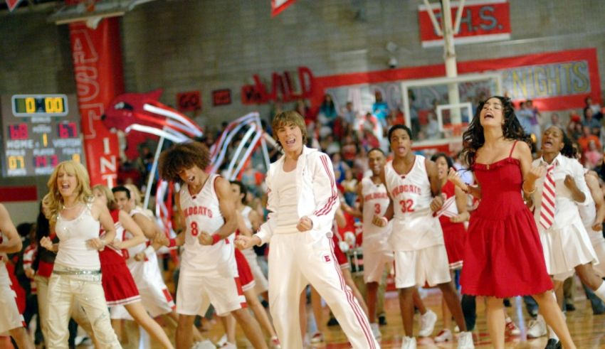 A group of people dancing on a basketball court.