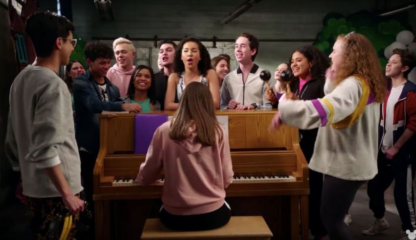 A group of people standing around a piano.