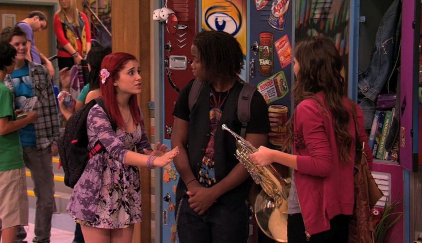 A group of people standing in front of lockers.